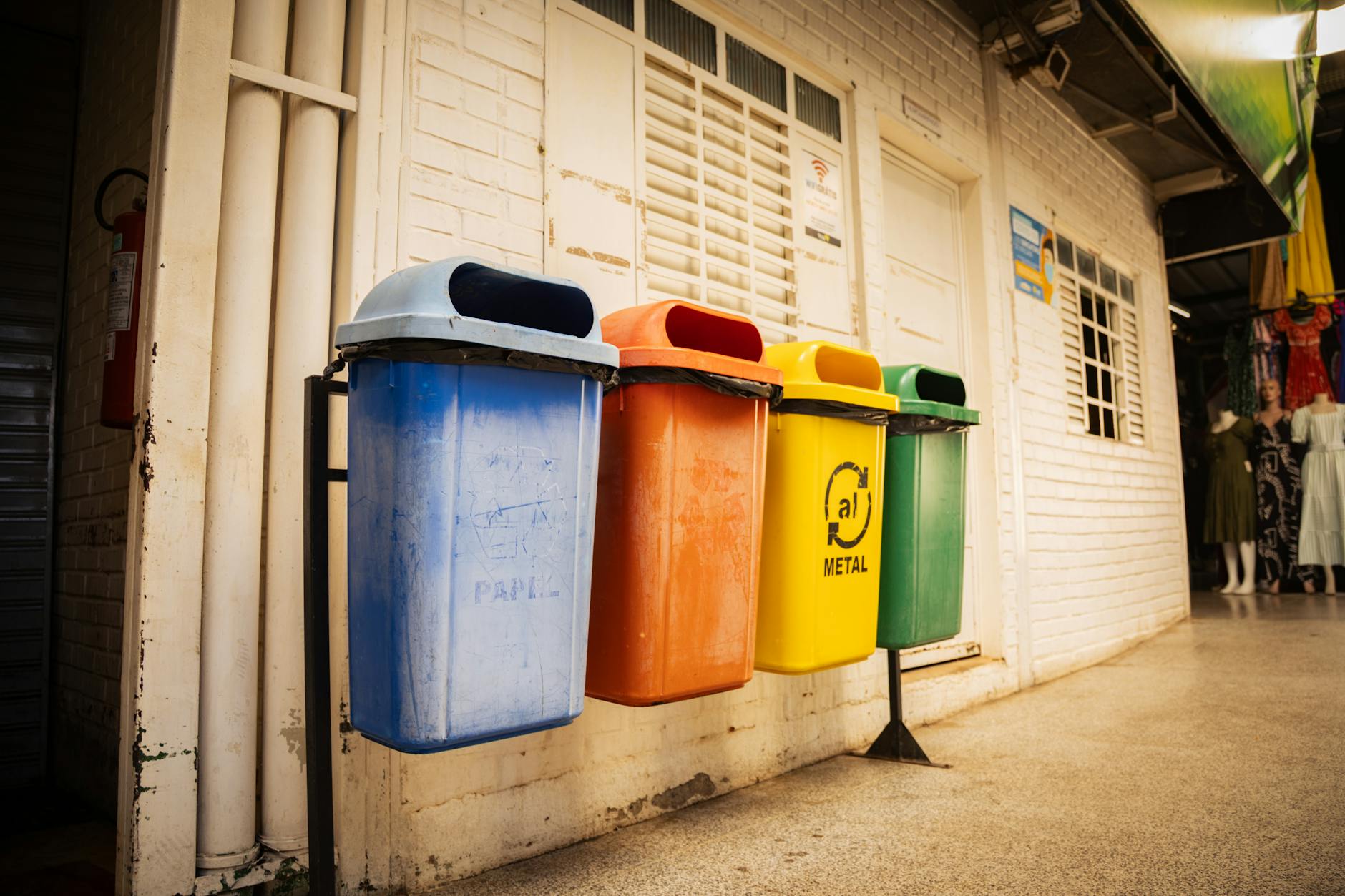 colorful recycling bins in market alleyway