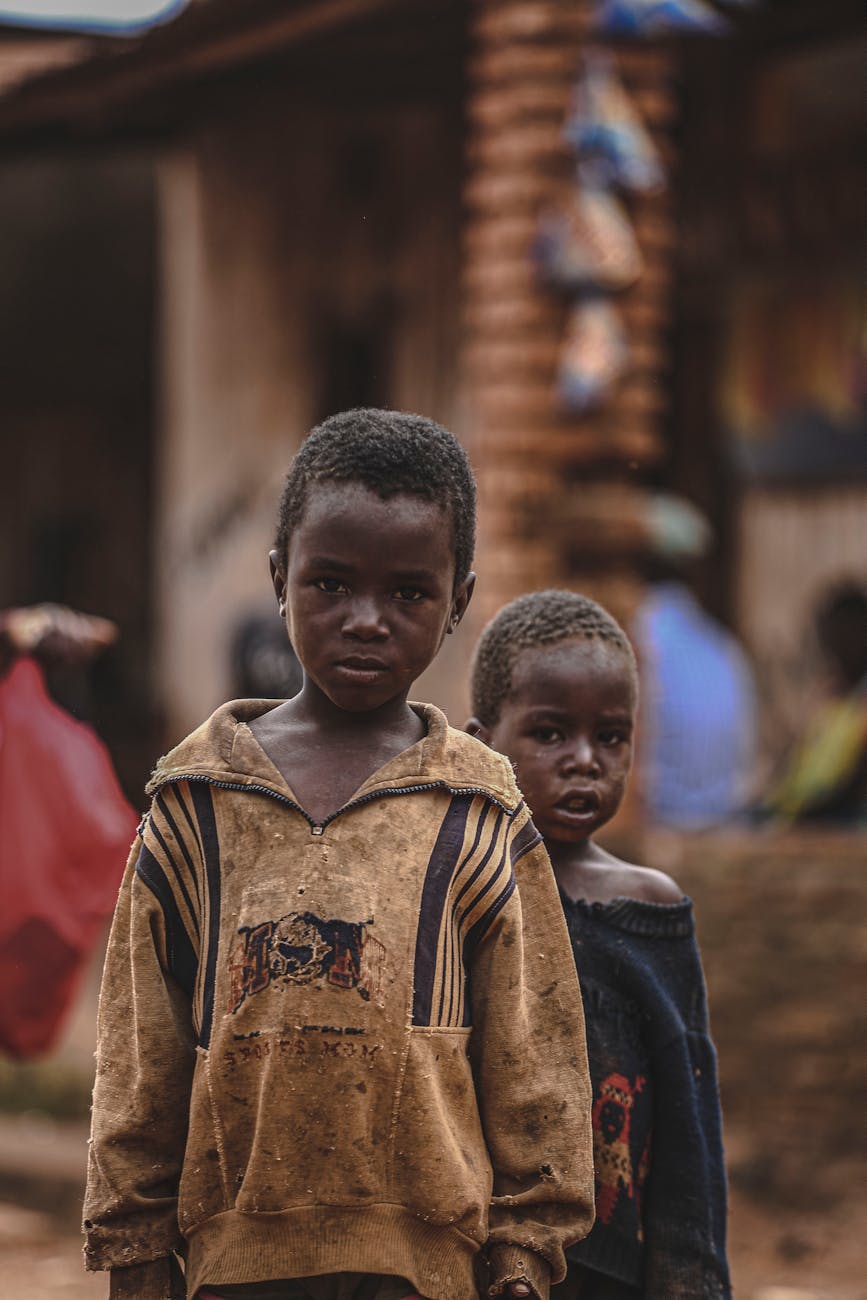 boys wearing damaged clothing on city street